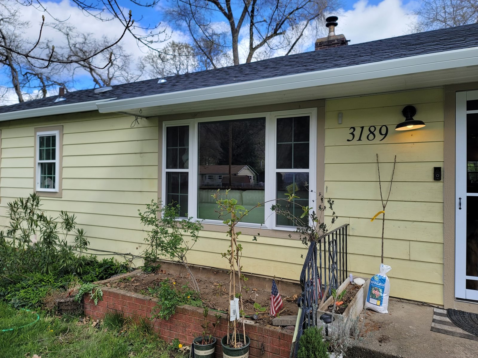 White-trimmed windows on a yellow house
