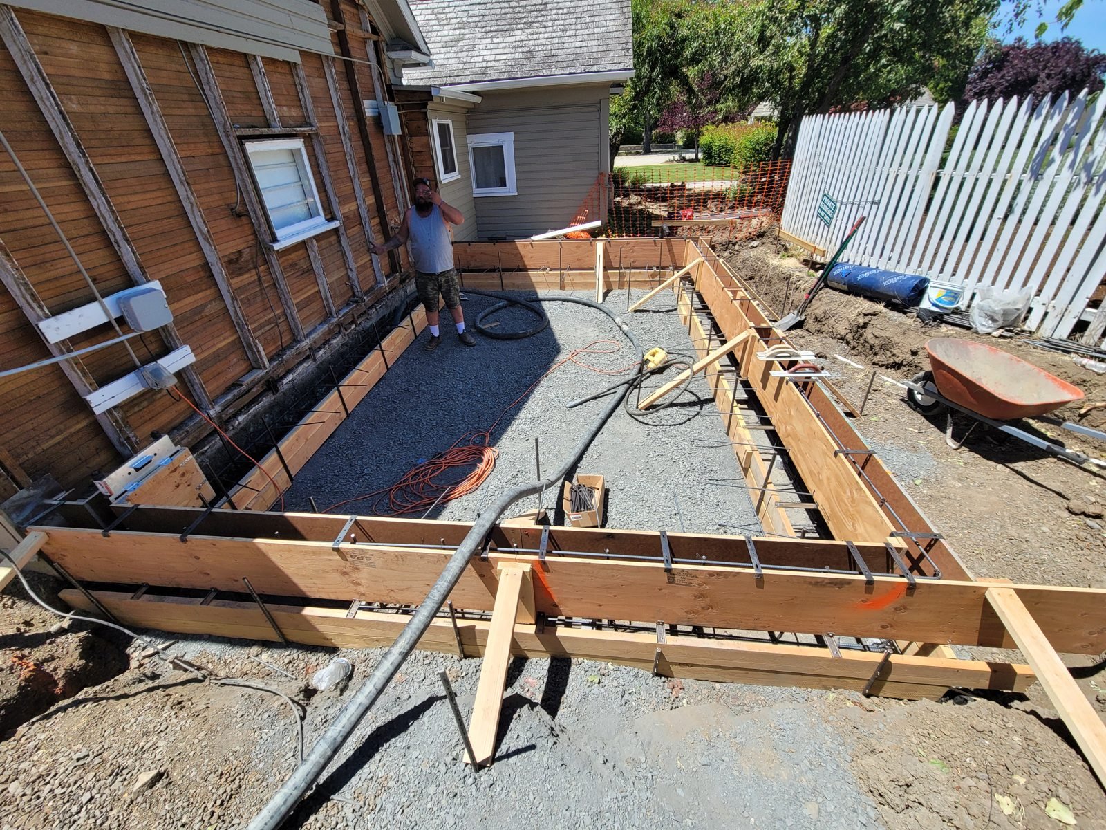 Concrete formwork beside a house before placement