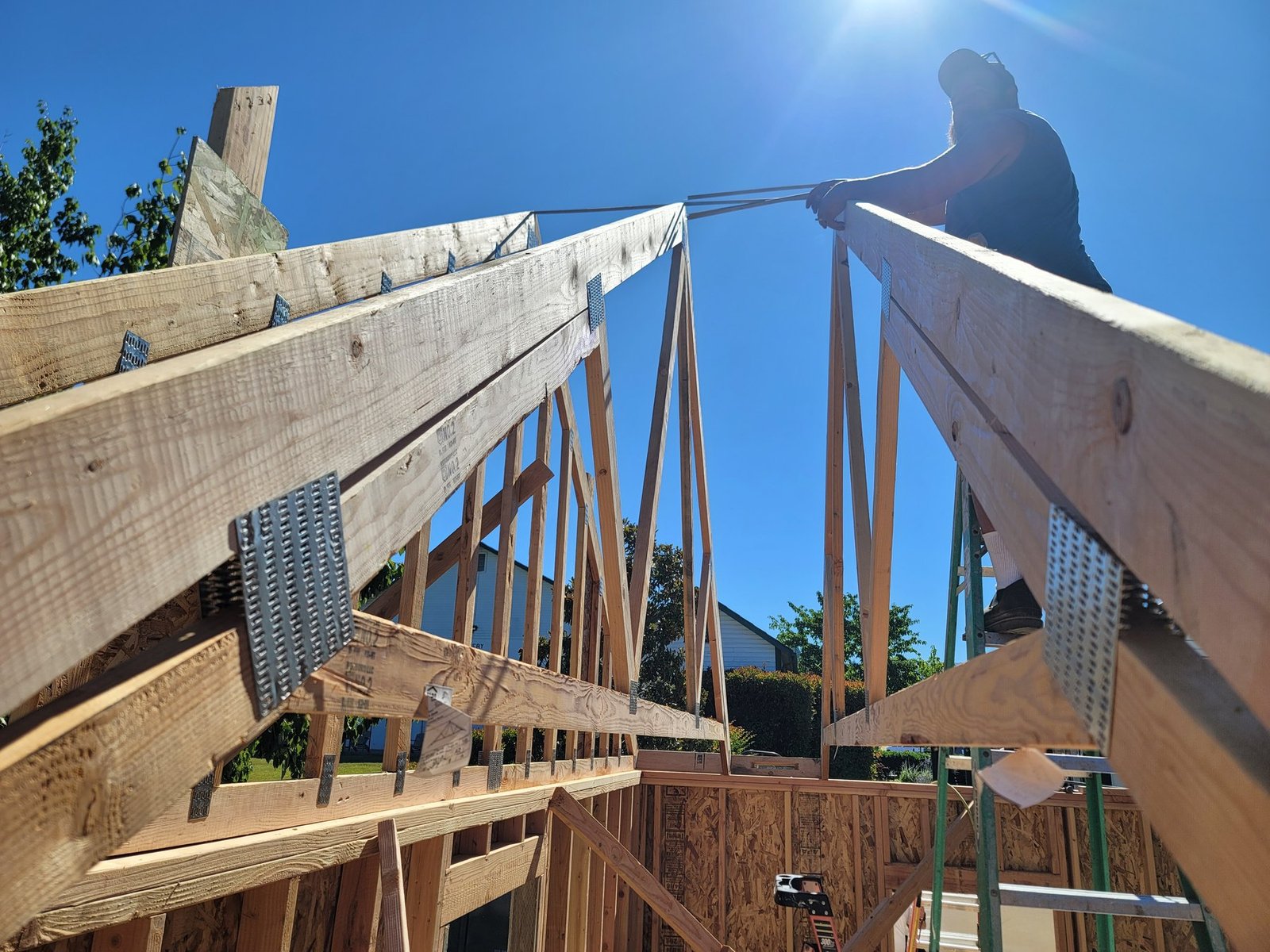 Builder positioning roof framing
