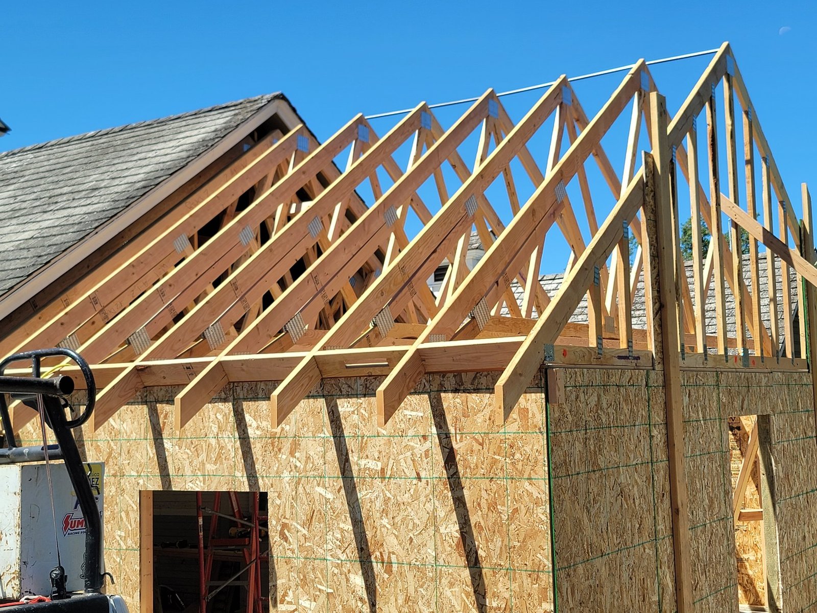 Timber roof trusses above wall sheathing