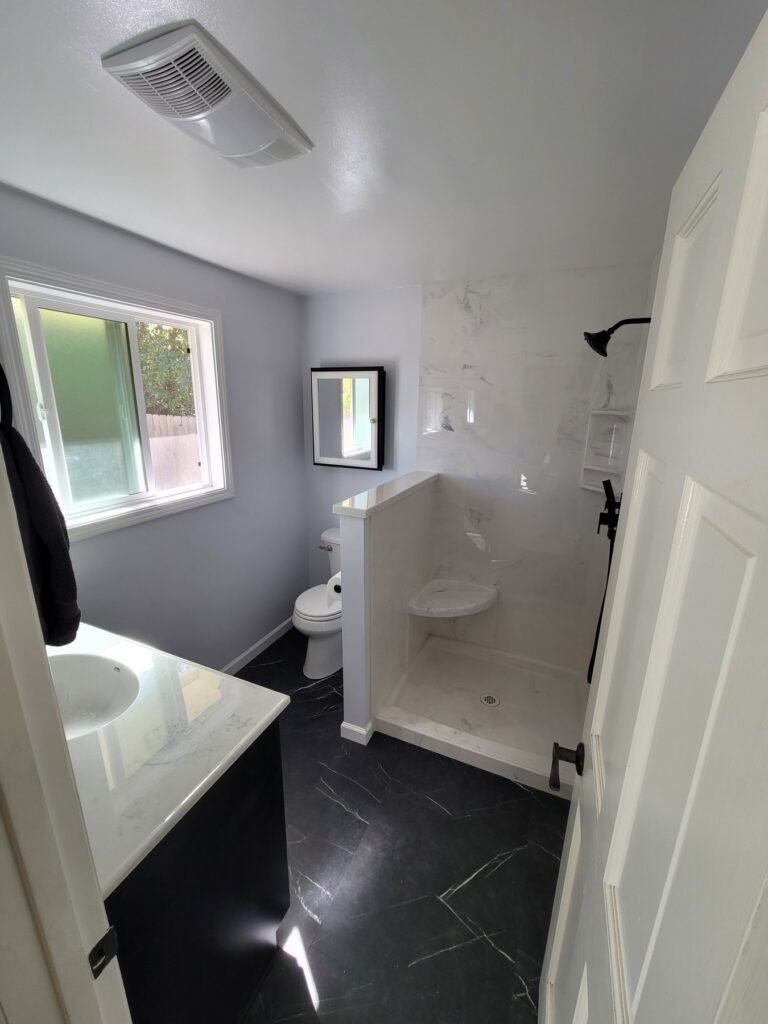 Bathroom with a white shower enclosure and frosted window