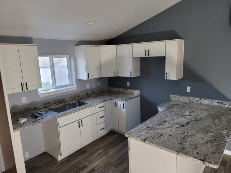 White kitchen cabinets and counters during installation