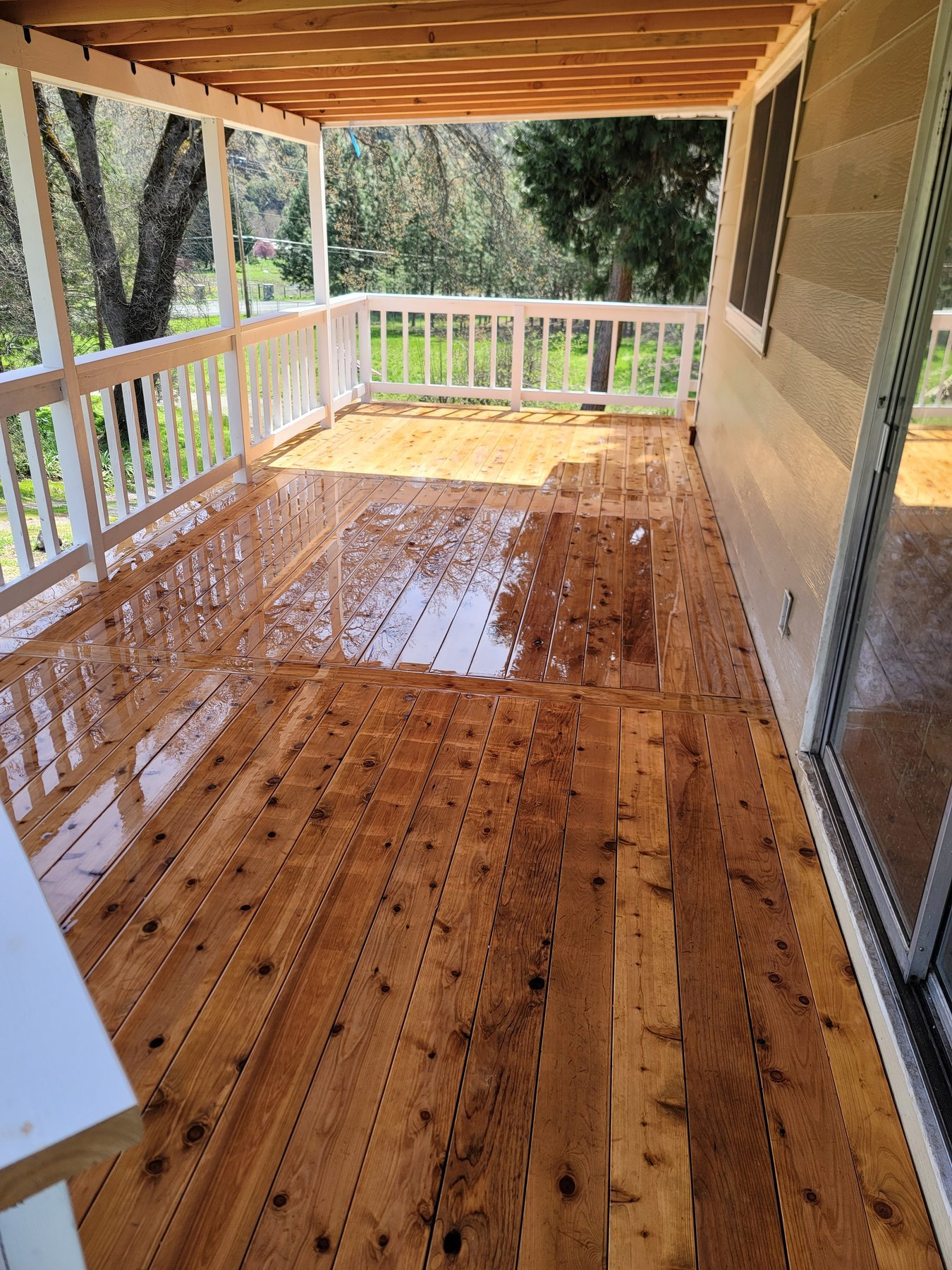 Wood porch floor with white railings