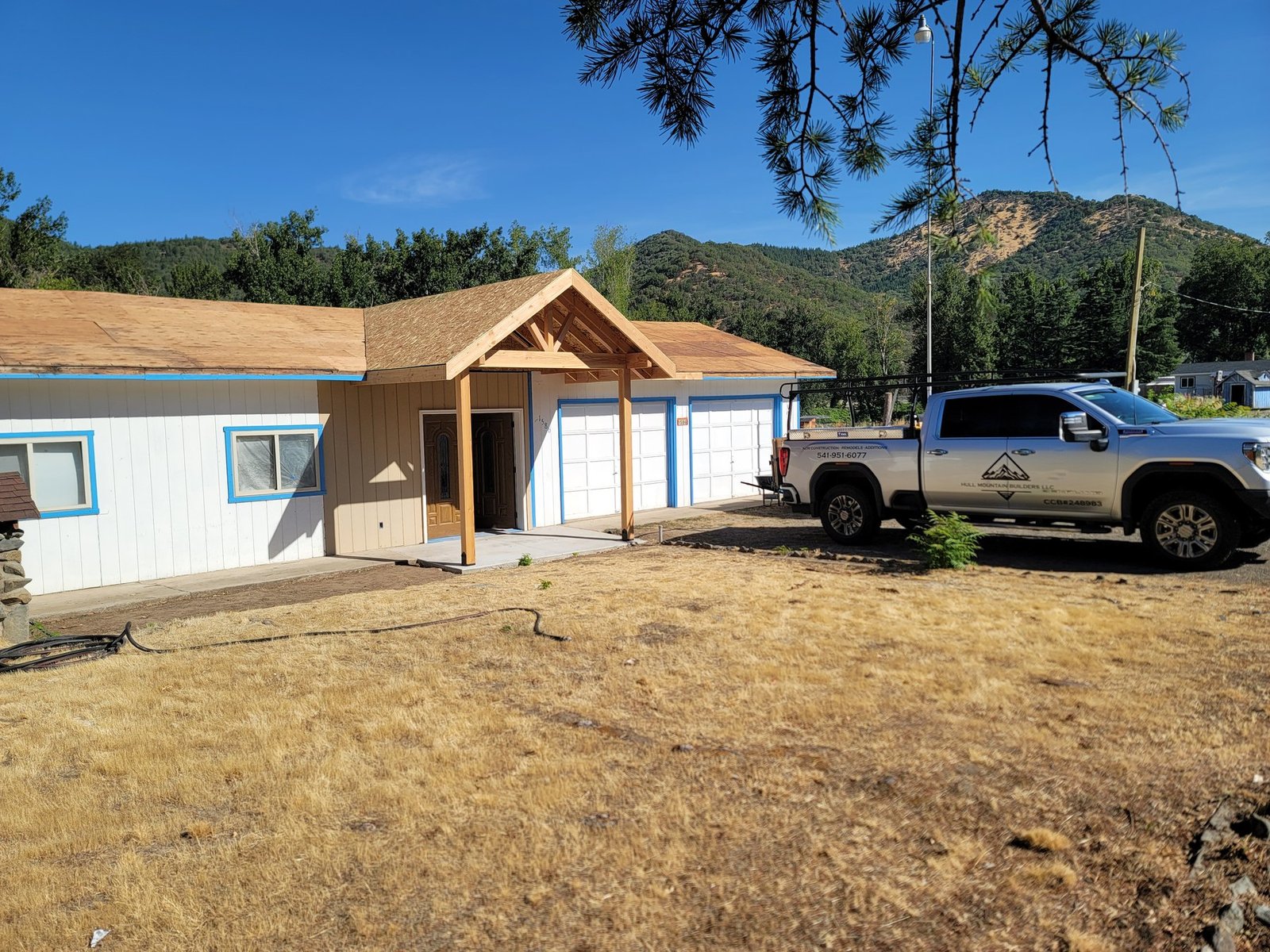 Gabled entry structure beside a garage