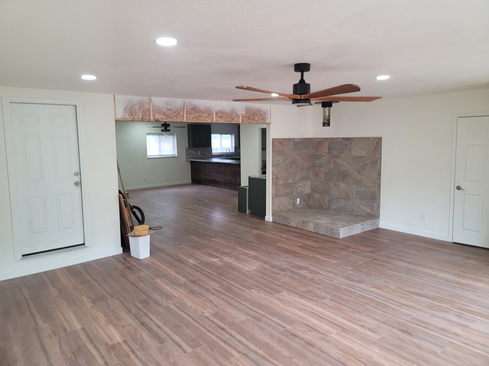 Interior room with wood-look flooring and a stone fireplace