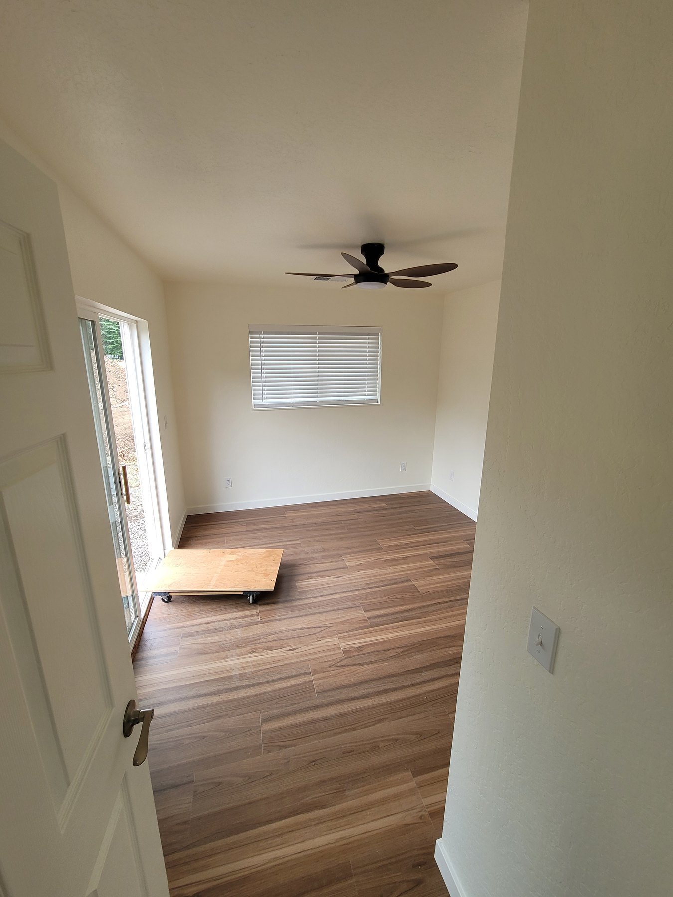 Room with wood-look flooring and a small window