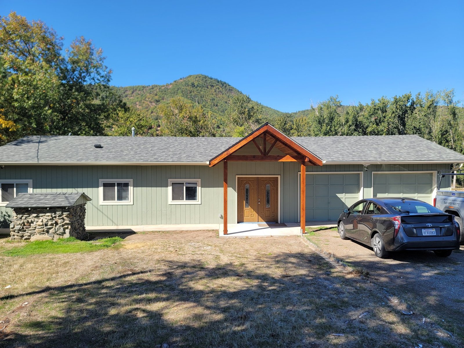 Home exterior with a timber-framed covered entry