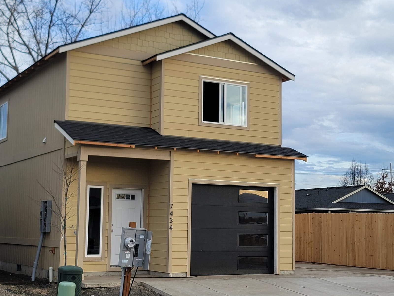 Two-story exterior with a garage and white-trimmed window
