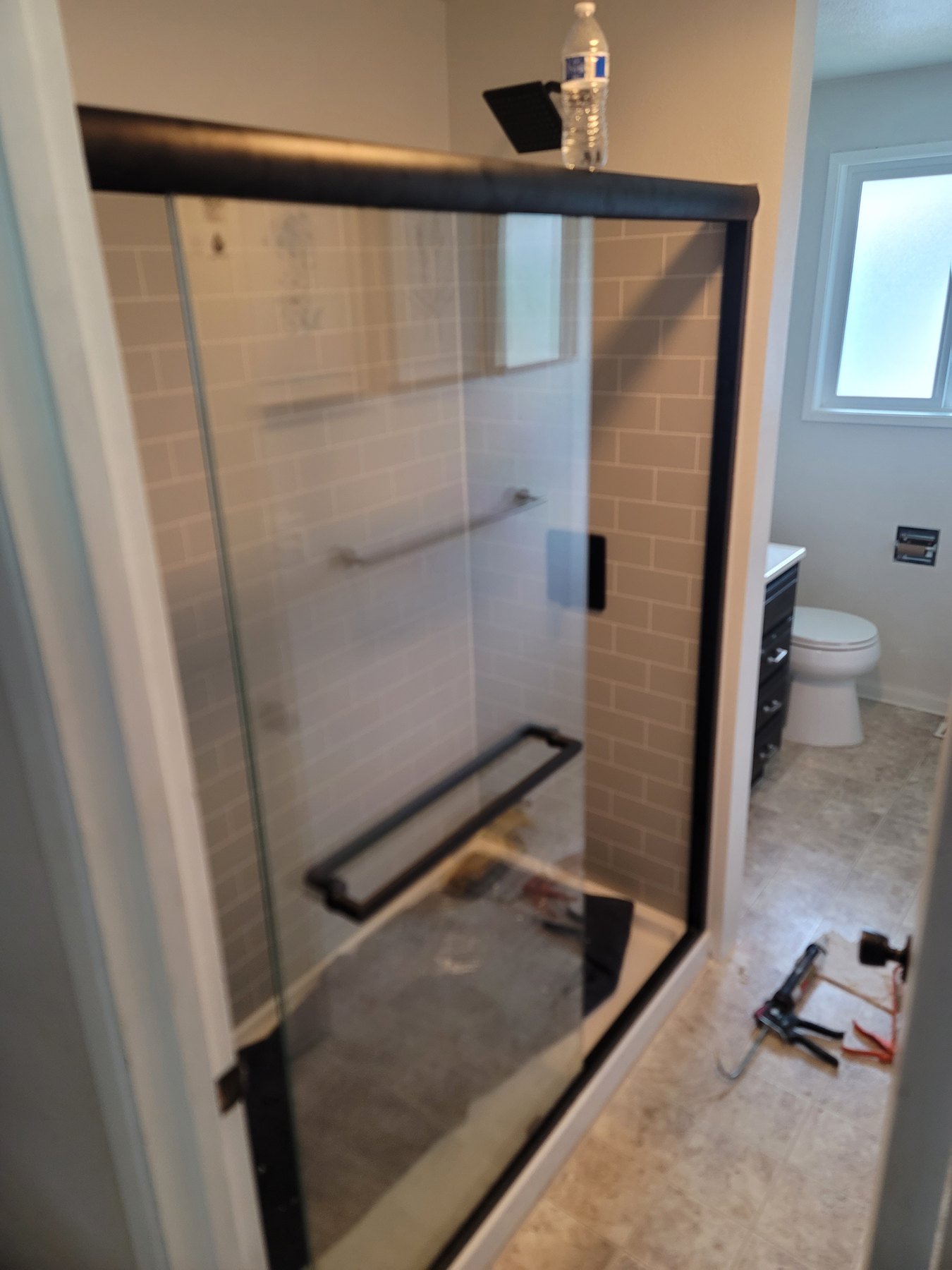 Bathroom with a black-framed glass shower enclosure